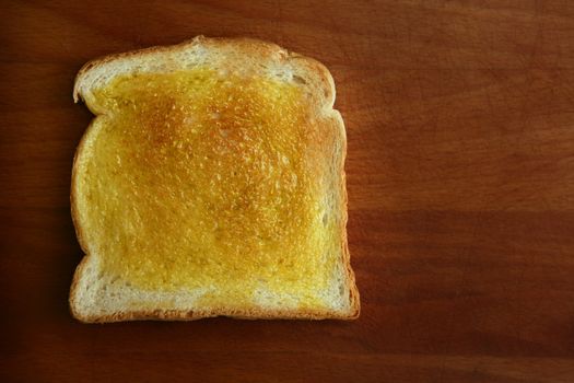 Delicious bread toast and olive oil over wood table