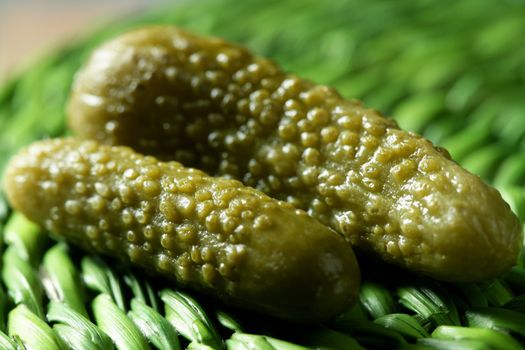 Green pickles macro detail studio shot, textured skin