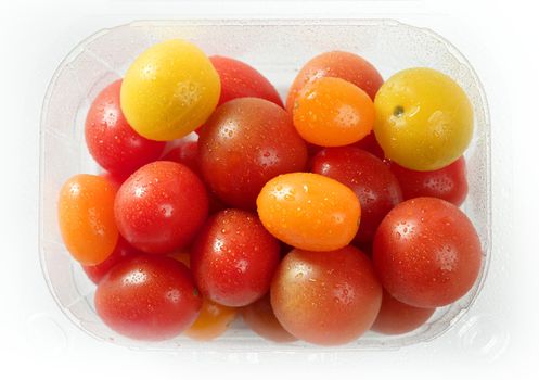 Little cherry varied multi color tomatoes, at studio, white background