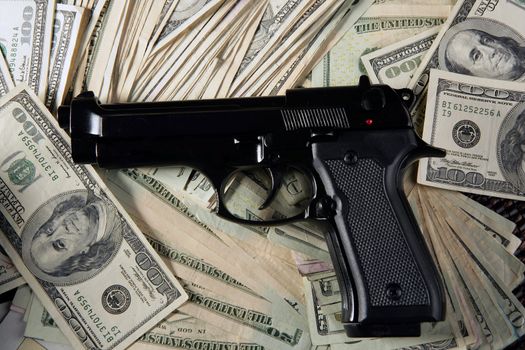 Dollar notes and gun, black pistol, mafia inspiration