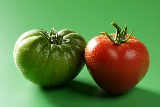 Two color tomatoes, green and red variety, studio shot