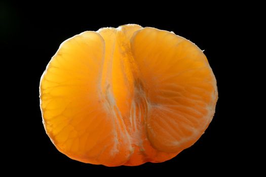 Tangerine macro segment over black background at studio