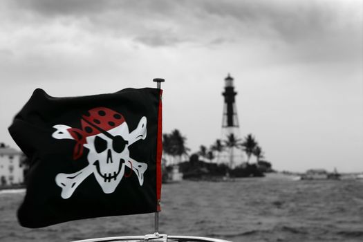 Pirates flag in black and red outdoor, lighthouse at the background, Florida