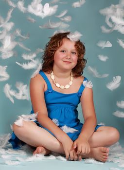 white feathers falling on a cute preteen girl