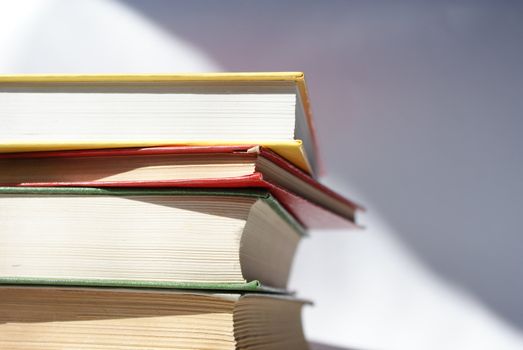 books of different colors stacked and shot in a closeup