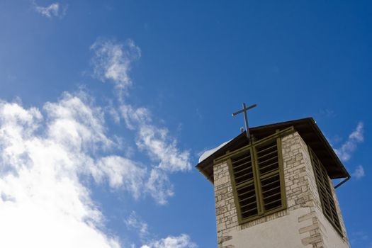 Holy church building with cross against blue sky