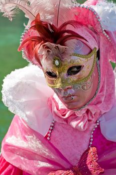 Carnival in venice with model dressed in various costumes and masks - pink lady