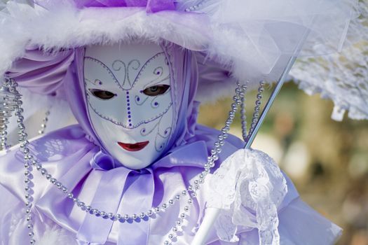 Carnival in venice with model dressed in various costumes and masks - violet lady