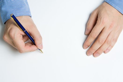 Person writing a message on a piece of paper or note