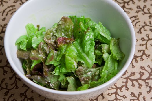 Fresh bowl of green salad with creamy white french dressing