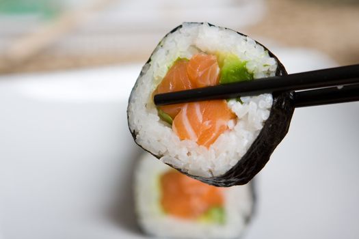 Fresh japanese salmon sushi served on a white plate