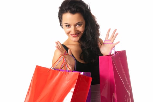 Young woman with shopping bags standing close-up isolated on white background