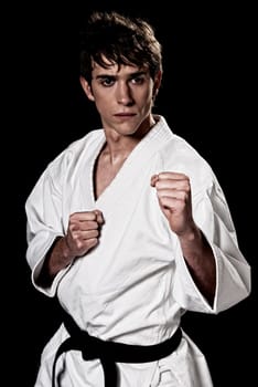 Karate male fighter young high contrast on black background
