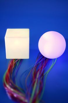 Glowing sphere and square with colorful wires, wired communication metaphor