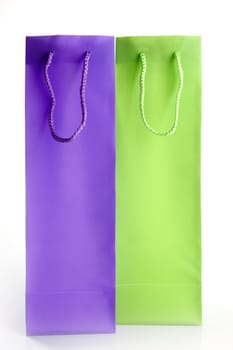 two tall shopping bangs, purple and green, isolated over white