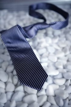 Businessman on a break, left his tie on a modern white stones table