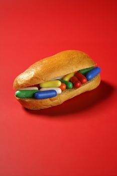 Sandwich made of colorful candy sweet, children favourites menu over red