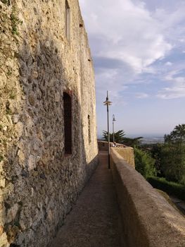 italy, tuscany, Capalbio town, tourists relax  and enjoy the sunset on external walls