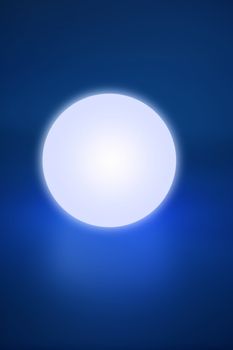 Abstract glowing light sphere over blue background