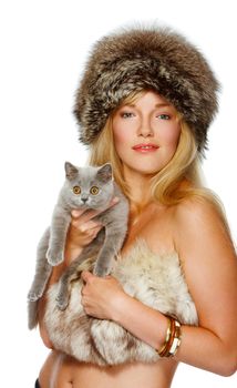 Beautiful young woman wrapped in fur on isolated background holding a cat
