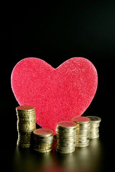 Love and money metaphor. Valentines candy heart and euro coins