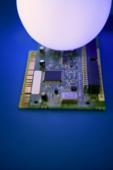 Glowing light sphere lighting a technologic electronic circuit