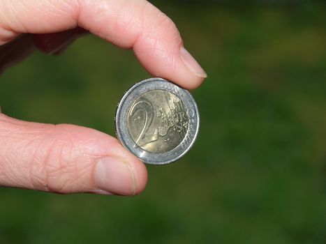 holding two euro coin