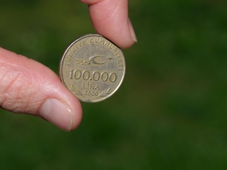 holding turkish coin