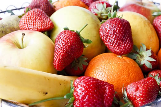 Many fruits close up strawberries, apples, lemons, oranges, bananas