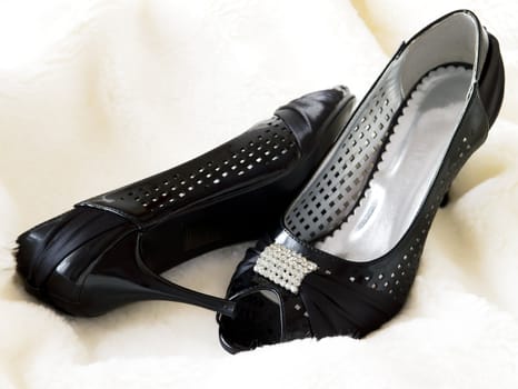 elegant black shoes on white fur
