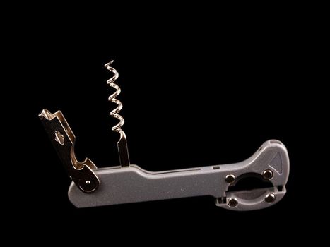 Bottle opener with screw, isolated towards black background