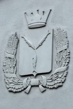 Bas-relief coat of arms of Saratov Region on the wall of the building