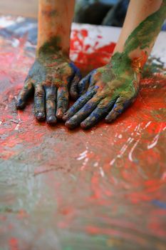 Children artist hands painting colorful with her fingers