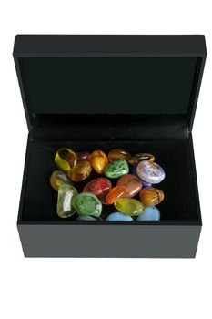 Colorful glass stones in a black box like a fake treasure chest