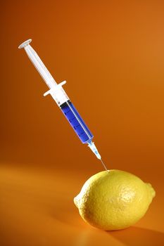 Bio genetics research of food , modified lemon with syringe