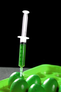 Bio genetics research of food , green modified eggs with syringe