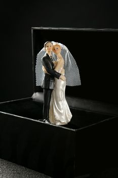 Marriage couple figurine in a black box, keeping as a treasure