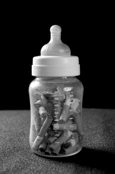 Tobacco addition metaphor with baby bottle full of cigarettes