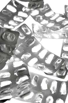 Pills tabs blister silver texture over white background