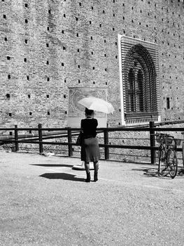 Fashionable tourist girl reading a map of town in Milan, Italy