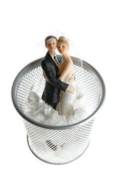 Wedding figurine on the paper trash as a divorce metaphor