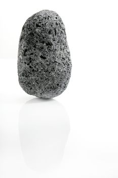 Volcanic Pumice, black and white textured stone over white