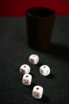 Poker game dices over black table, low key image