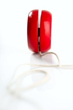 Red yoyo with thread isolated over white background