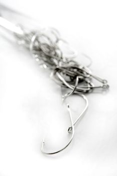 fishing hooks over white background, fisherman equipment