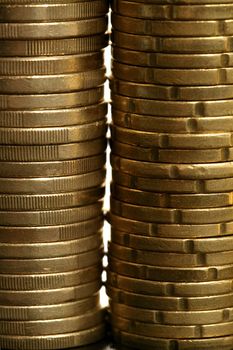 Euro coin columns, golden cash over white background at studio