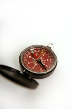 Red open magnetic compass, white background