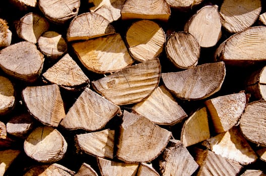 Fragment of choppen firewood. Wooden texture background .