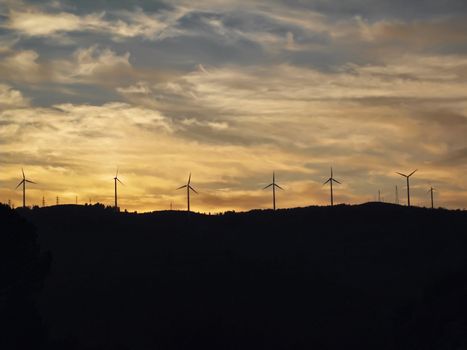 ITALY, Campania, Salerno, countryside, Eolic energy turbines at sunset                              