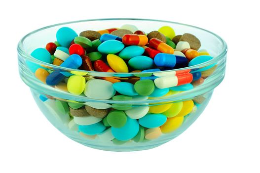 some different pills in a glass bowl 